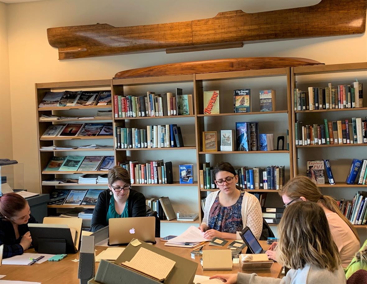 Image of graduate students at work in archive