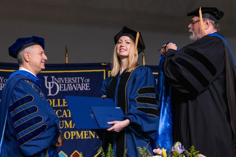 From left to right, UD President Assanis; Jessica Conrad, dissertation award winner; John Ernest, chair of the Department of English.