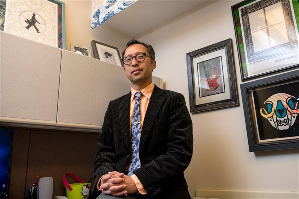 Viet Dinh, an award-winning fiction writer and assistant professor of English, in his office at UD. 